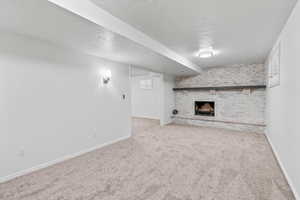 Below grade area with a fireplace, and new carpet