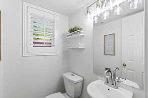 Half bathroom with a sink and toilet