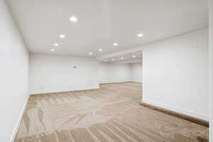 Finished basement featuring recessed lighting and light colored carpet
