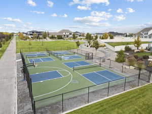 View of sport court featuring a tennis court, a residential view, and community basketball court