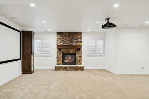 Cinema featuring light colored carpet, a fireplace, and recessed lighting