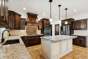 Kitchen featuring decorative backsplash, dark brown cabinets, decorative light fixtures, and recessed lighting