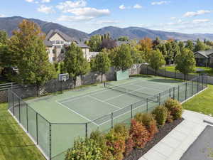 View of tennis court featuring a mountain view and community basketball court