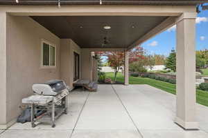 View of patio with a ceiling fan and area for grilling