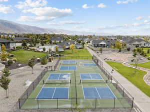 View of tennis court featuring a residential view and a mountain view