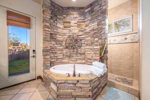 Full bathroom with a bath and tile patterned floors