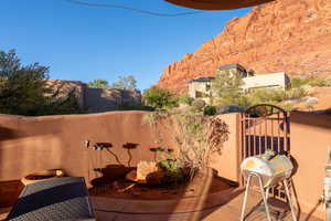 Patio / terrace featuring a gate, area for grilling, and a mountain view