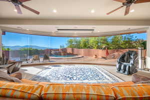 Living room with a ceiling fan, recessed lighting, and a mountain view