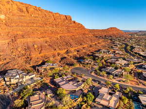 Aerial view of property's location with a mountain backdrop and nearby suburban area