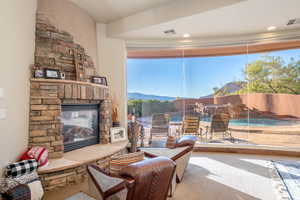 Living area featuring a fireplace, carpet floors, and a mountain view