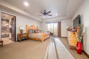 Bedroom featuring a tray ceiling, access to outside, light colored carpet, ceiling fan, and recessed lighting