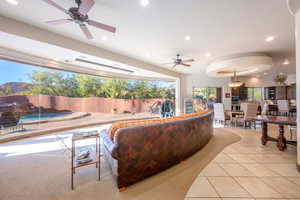 Living area with light tile patterned floors, ceiling fan, and recessed lighting