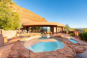 View of pool with a fenced backyard, an in-ground hot tub, and a patio