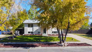 View of front of home featuring brick siding, covered porch, and driveway