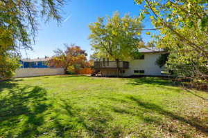 View of yard featuring a deck and stairway