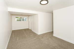 Carpeted empty room featuring a textured ceiling