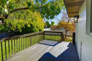 Wooden deck with a fenced backyard