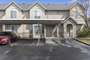 View of front of property with stone siding and stucco siding