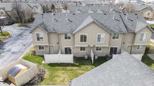 Back of property featuring stucco siding, a residential view, and a fenced backyard