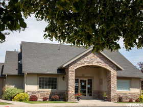 View of front facade featuring stone siding and stucco siding