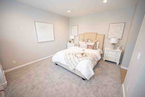 Carpeted bedroom with recessed lighting