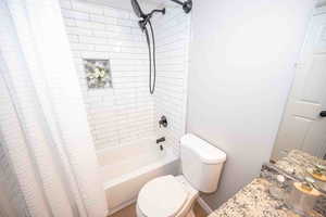 Bathroom featuring shower / bath combo and vanity
