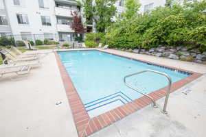 Community pool featuring a patio