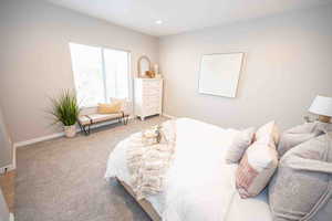 Carpeted bedroom featuring baseboards and recessed lighting