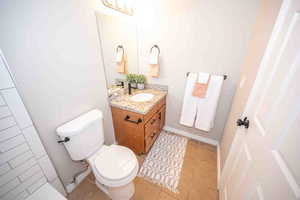 Half bathroom with vanity and light tile patterned floors