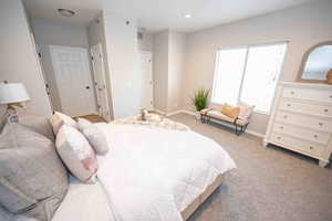 Bedroom with carpet, connected bathroom, and recessed lighting