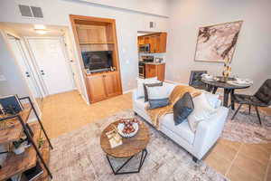 Living room featuring light tile patterned floors and baseboards
