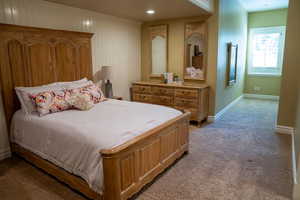 Bedroom featuring light colored carpet and baseboards