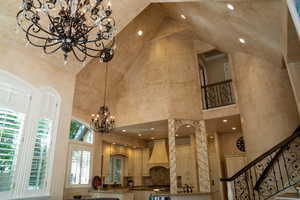 Community lobby with high vaulted ceiling, recessed lighting, and stairs
