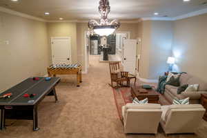Recreation room with recessed lighting, crown molding, and carpet flooring