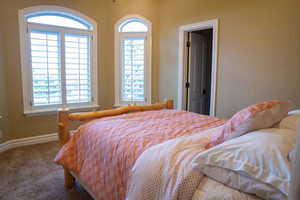 Carpeted bedroom with baseboards