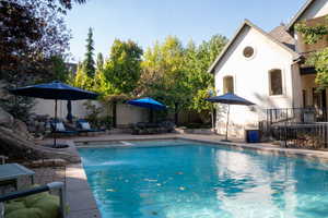 View of pool featuring a patio and a pool with connected hot tub
