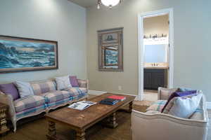 Carpeted living room featuring baseboards