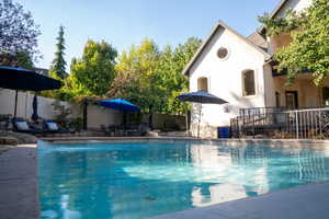View of swimming pool with a patio area and a fenced backyard