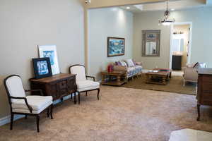 Living area with light carpet and baseboards