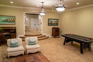 Game room with ornamental molding, carpet floors, and recessed lighting