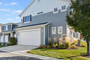 2 car garage with overhead shelving, plus driveway parking (large enough to accommodate a truck parked diagonally). Convenient street parking for guests — just no overnight parking.