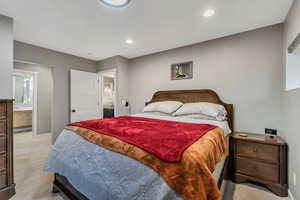 Bedroom with ensuite bathroom and recessed lighting