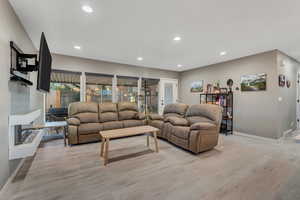 Living area featuring recessed lighting and light wood-style flooring