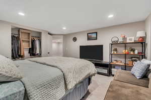 Bedroom with recessed lighting and light colored carpet