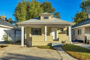 Bungalow with a porch and a shingled roof