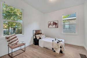 Bedroom with light wood-type flooring and baseboards