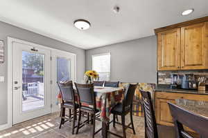 Dining room with dark tile patterned flooring