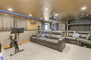 Carpeted home theater featuring recessed lighting and a textured ceiling