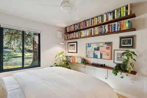 Bedroom featuring a ceiling fan and baseboards