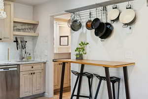 Mudroom with a sink and light wood-style flooring